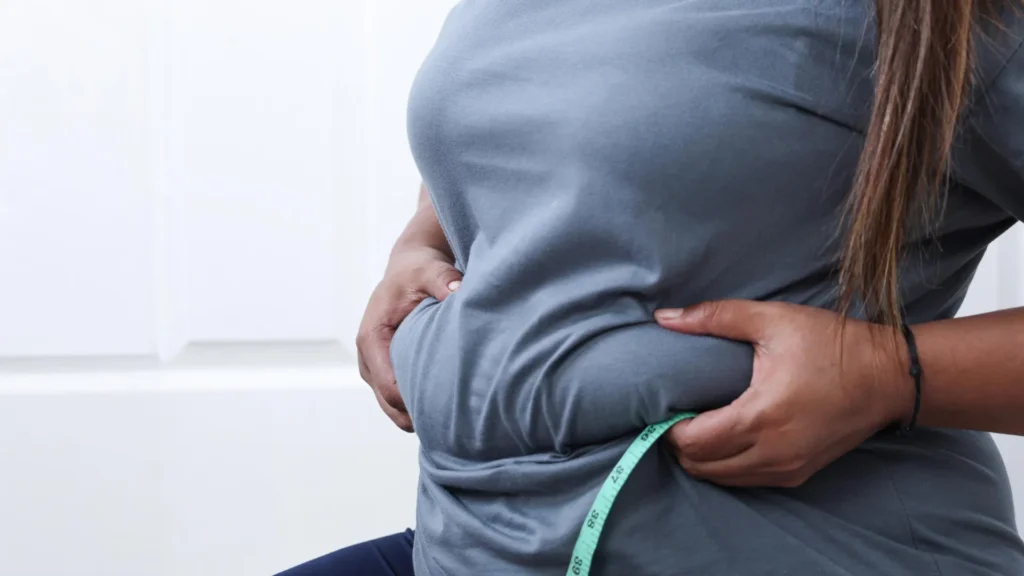 heavy-woman-pinching-belly-fat.webp.webp