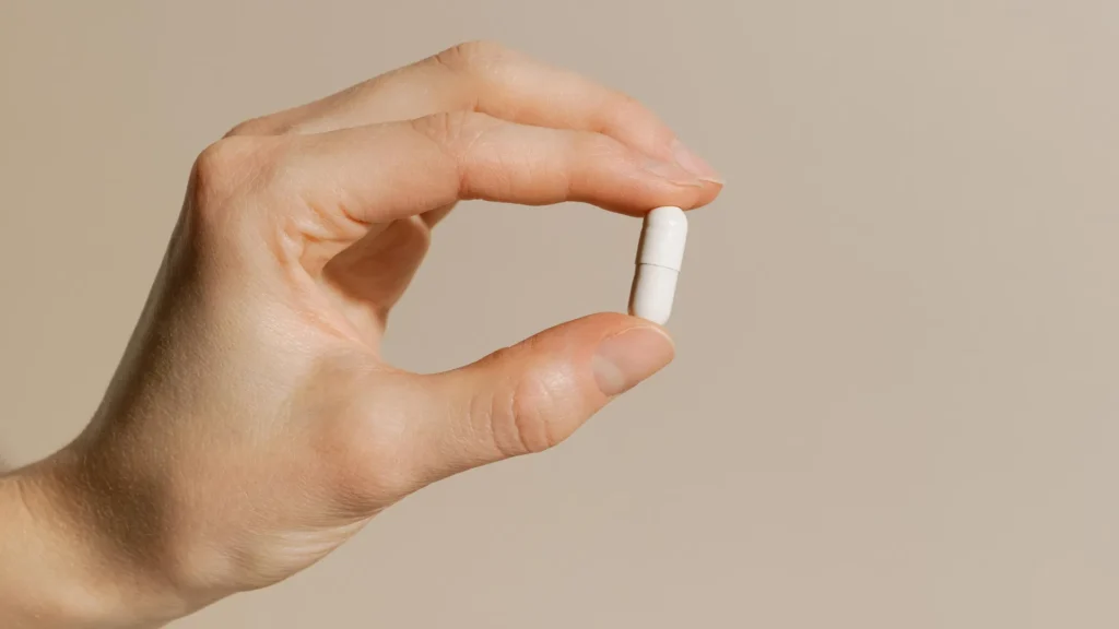 woman-hand-holding-vitamin-supplement-capsule.webp.webp
